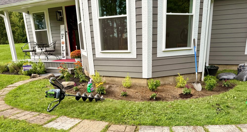 Freshly dug beds in front of the dining room with eGo battery-operated auger.