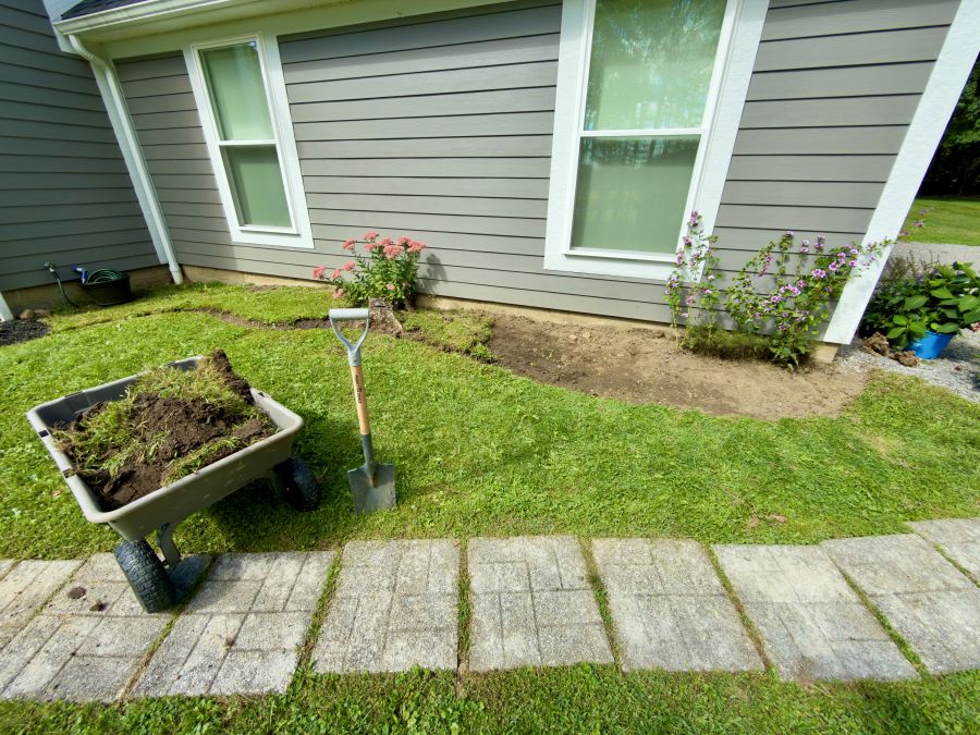 Digging the bed in front of the garage with garden wagon.