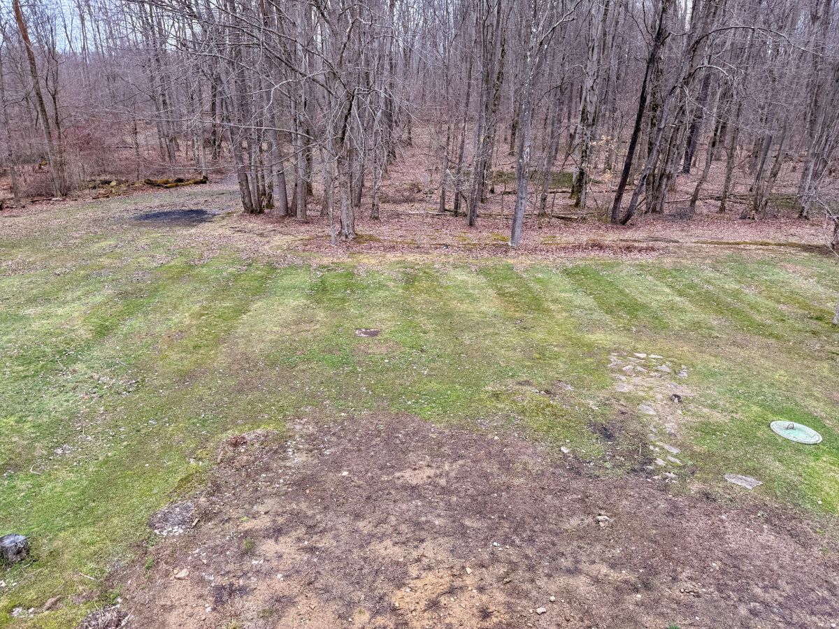 Preparing compacted clay and burn-pile soil for spring grass seeding.