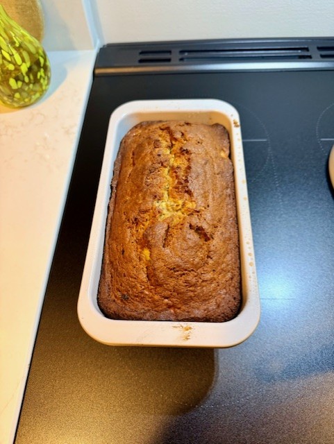 Freshly baked banana bread loaf cooling on the counter