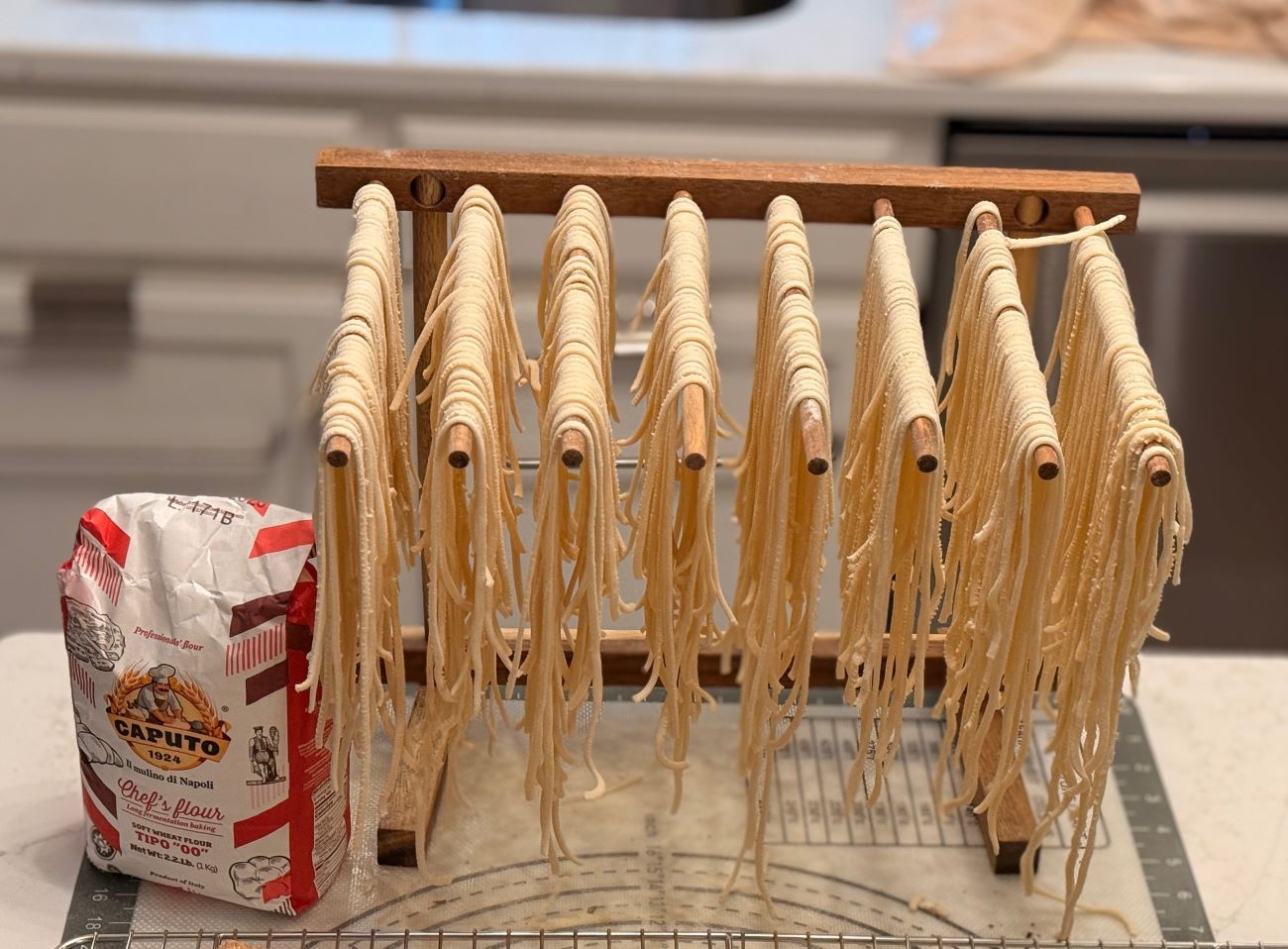 Flour, fresh pasta, and cookies arranged on the counter