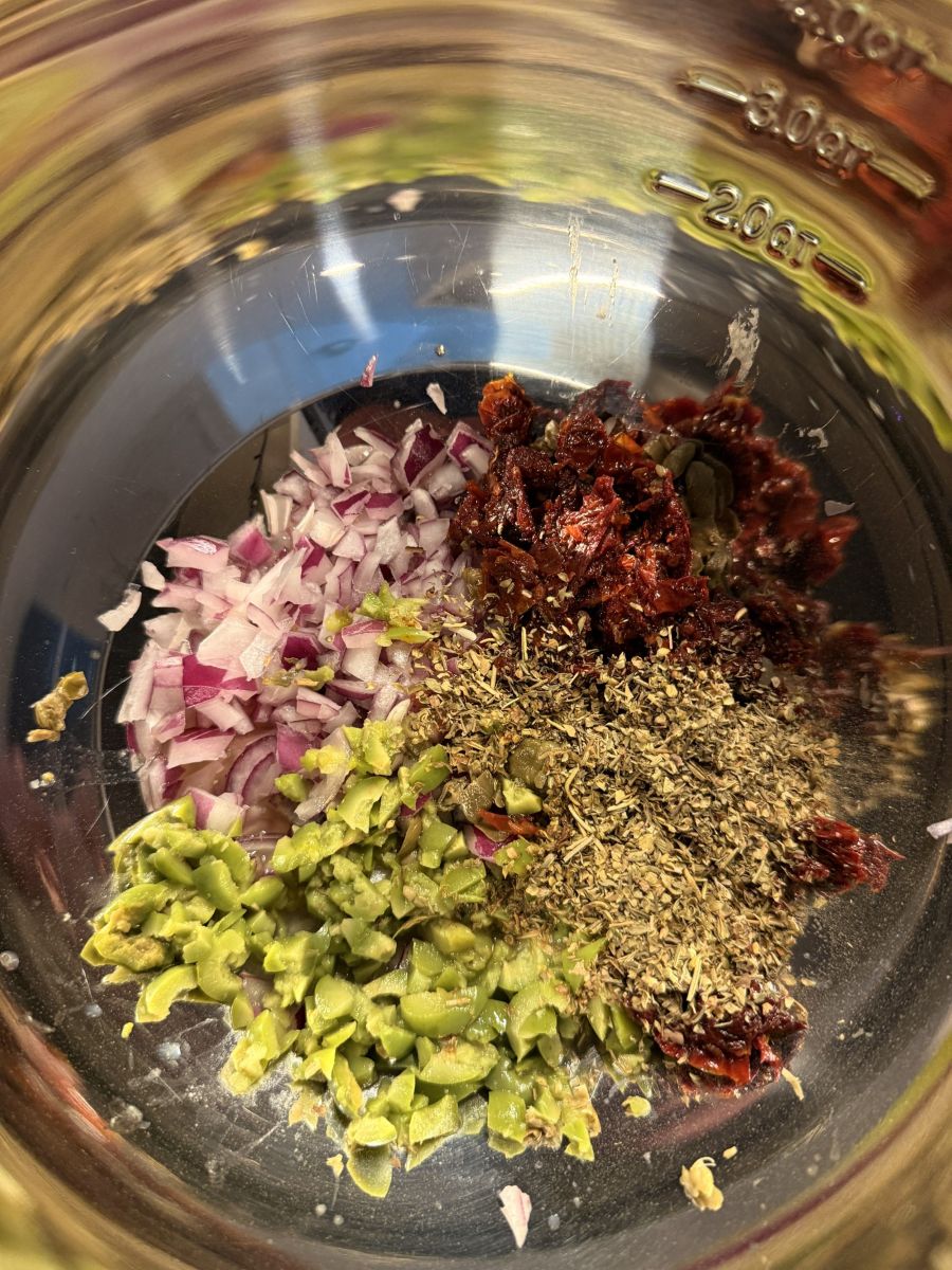 Mediterranean aromatics and ingredients in a mixing bowl