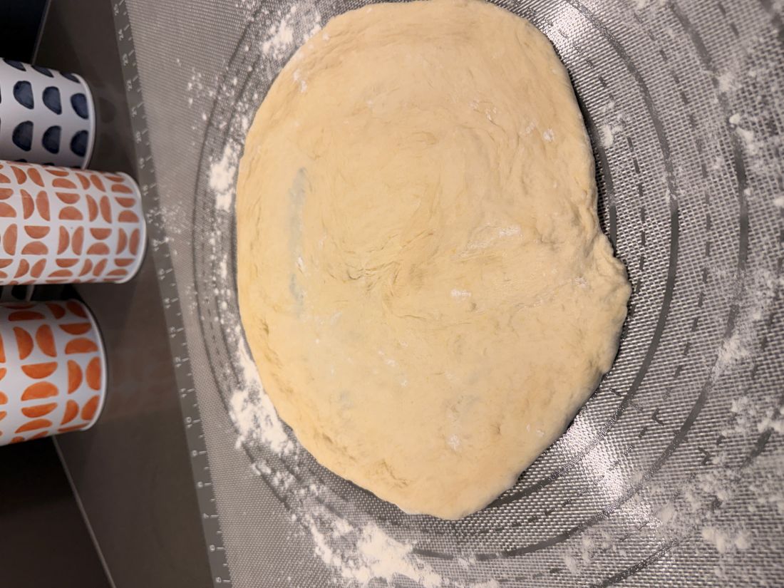 The fresh dough stretched out into a rough, rustic 12-inch circle