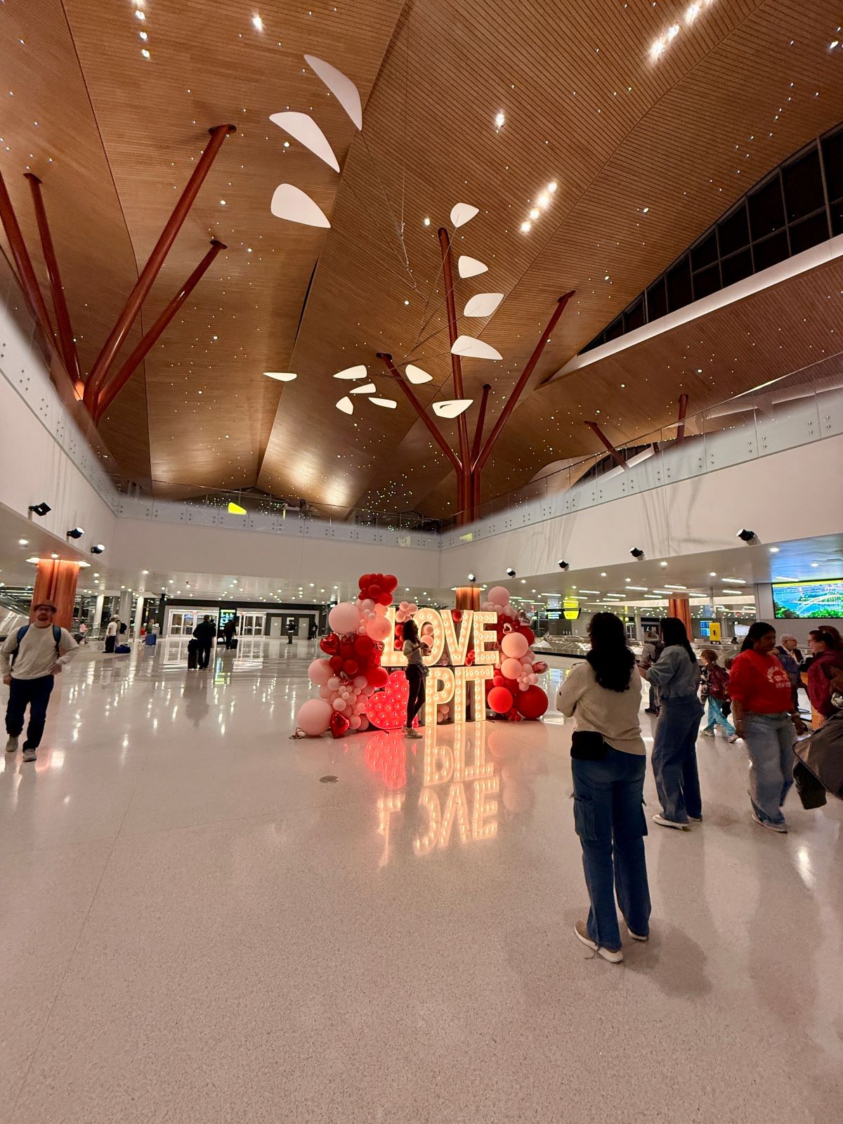 New Pittsburgh International Airport terminal interior showing wood-paneled ceilings and natural light